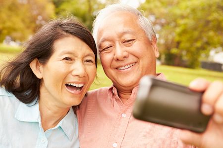 couple taking a selfie together after their restorative dental treatment in Vancouver, WA