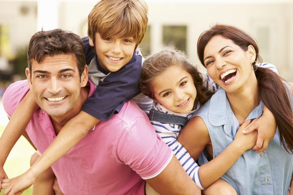 family of four with bright shiny smiles